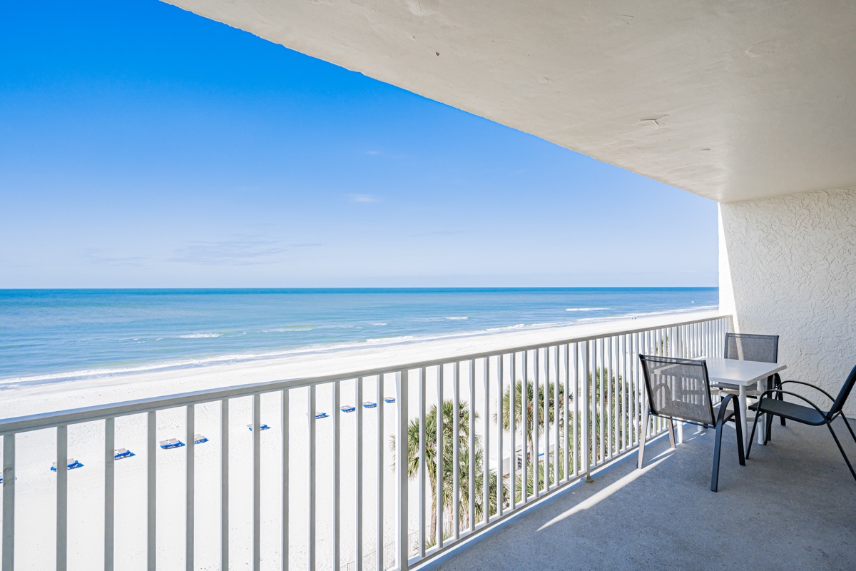 Your private balcony offers stunning beachfront views where you can sip morning coffee while watching waves roll onto pristine white sand below.