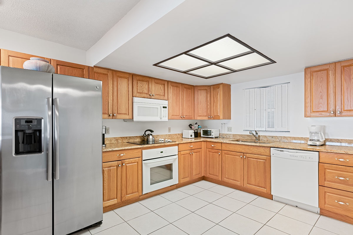Your fully equipped kitchen features granite countertops, stainless steel appliances, and warm wood cabinetry for all your culinary adventures.