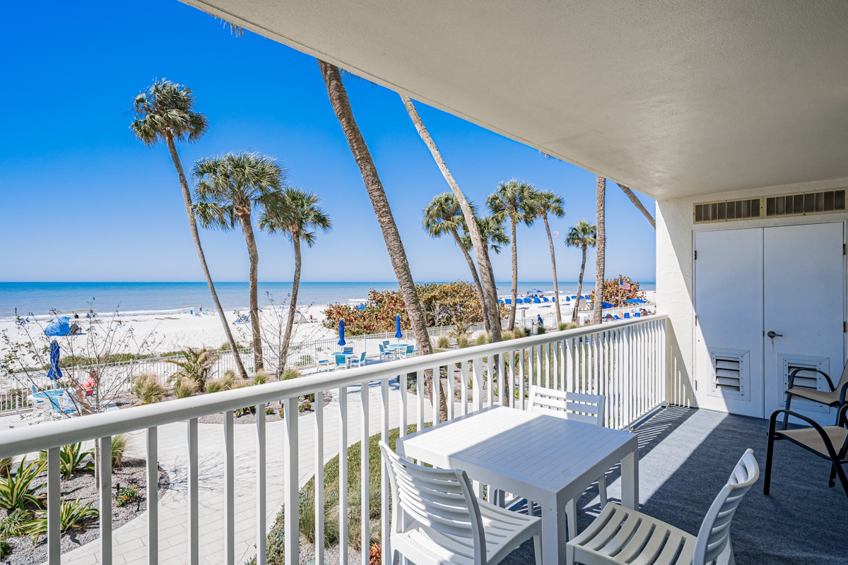 Your private balcony overlooks pristine white sand and swaying palms, where ocean breezes and endless blue horizons create the perfect backdrop for morning coffee.