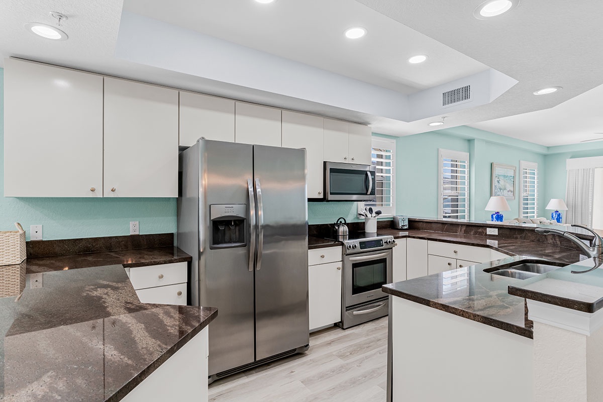 Your fully equipped kitchen features modern stainless steel appliances and granite countertops, perfect for preparing memorable vacation meals.