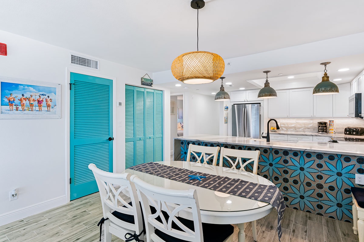 Gather around your stylish dining table beneath elegant pendant lights, with the fully-equipped kitchen just steps away for effortless meal prep.