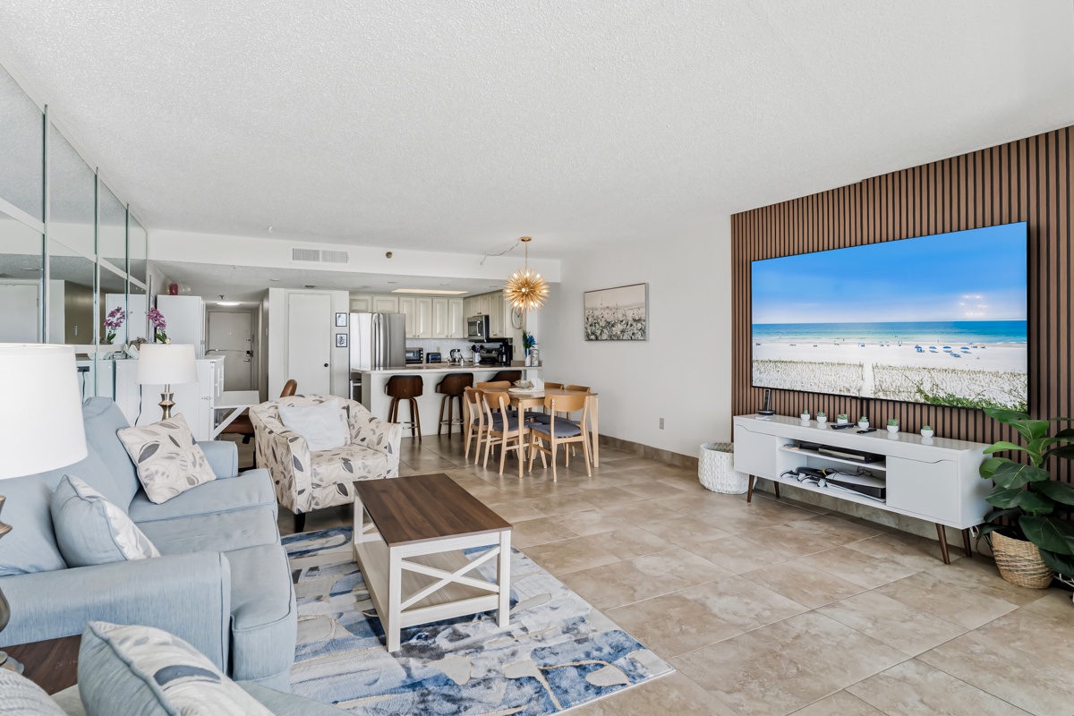 Step into your coastal retreat with an open-concept design that blends living, dining, and kitchen into one inviting space. Soft blue tones and natural textures create a calm, airy feel—perfect for unwinding after a day at the beach.