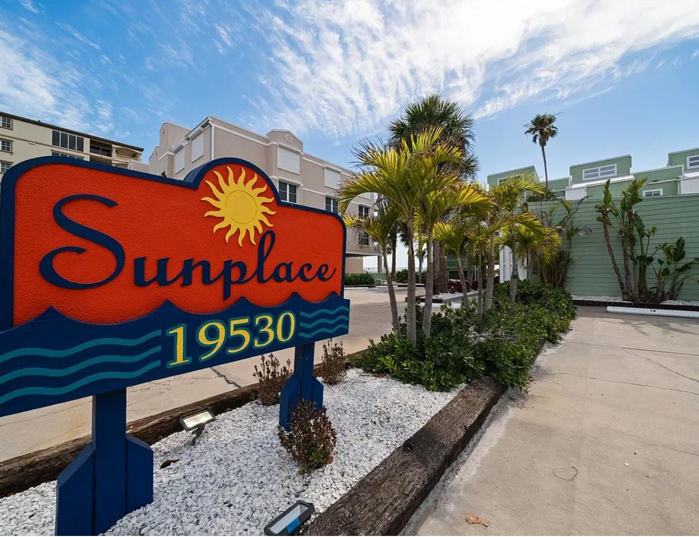Sunplace property entrance sign welcomes visitors to this tropical vacation rental community with colorful beach-themed branding.