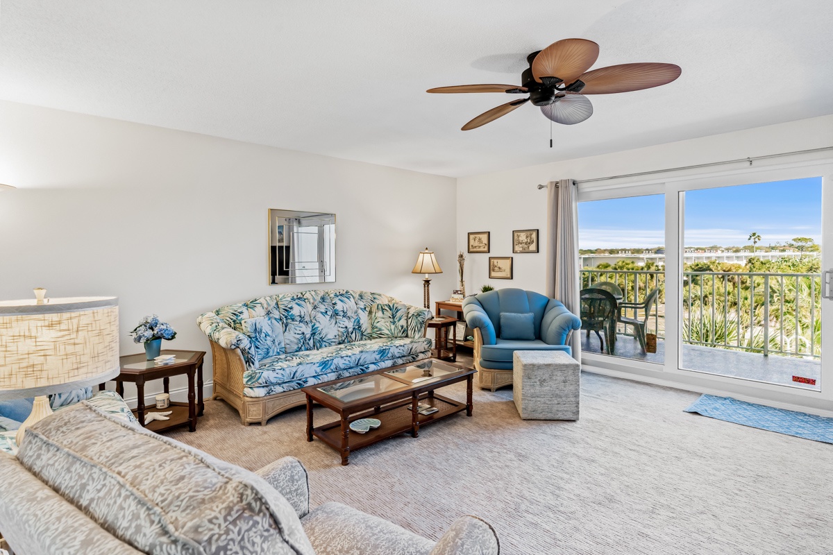 Relax in your bright, tropical-themed living room with comfortable seating and tropical breezes from your private balcony.