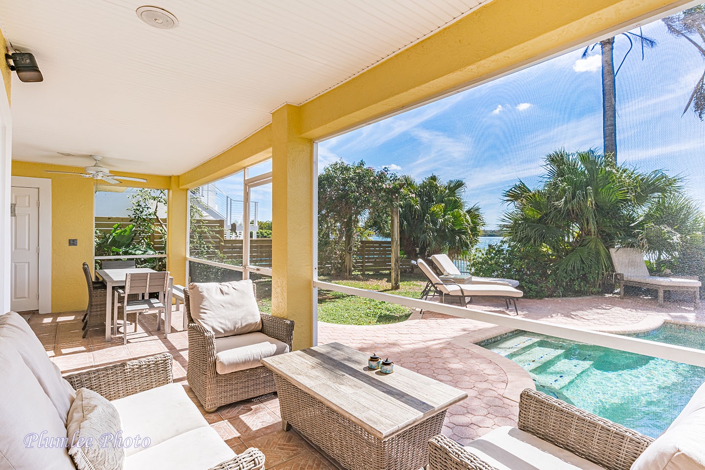 A view of the pool and blue sky from the lanai.