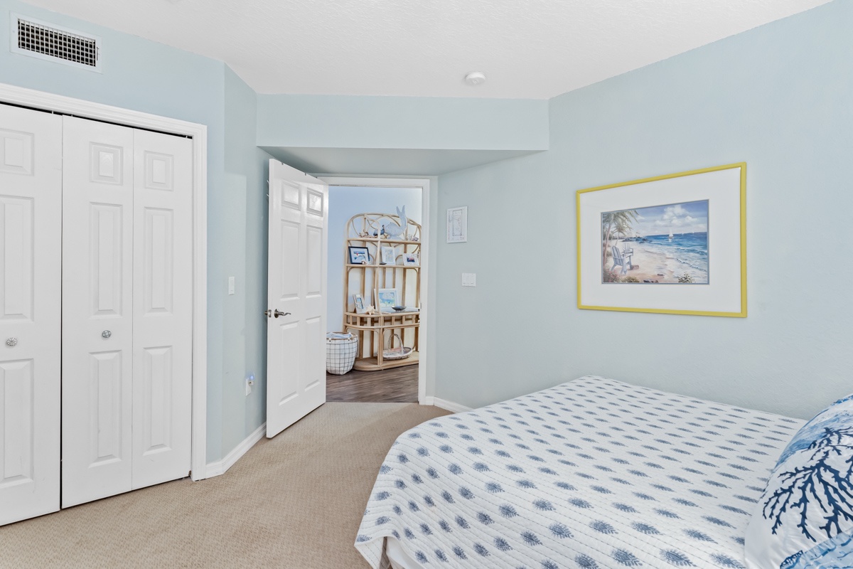 Wake up in your tranquil coastal bedroom, where soft blue walls and ocean artwork create the perfect seaside sanctuary for restful nights.