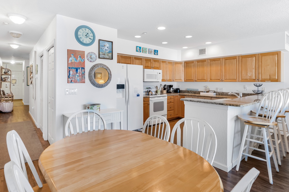 Your spacious kitchen and dining area combines modern appliances with coastal charm, perfect for preparing meals and gathering together.