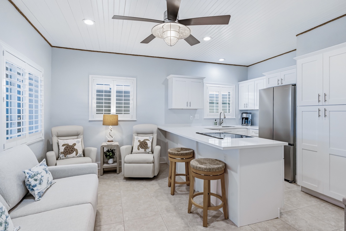 Your open-concept kitchen flows seamlessly into a cozy living area where you can whip up meals and relax together.
