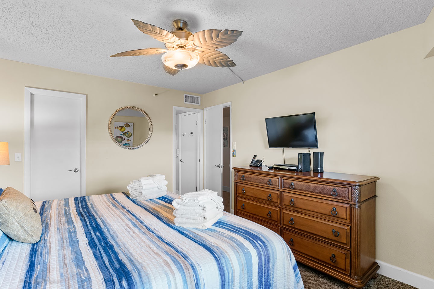 Bedroom has plenty of storage with closet and dresser.