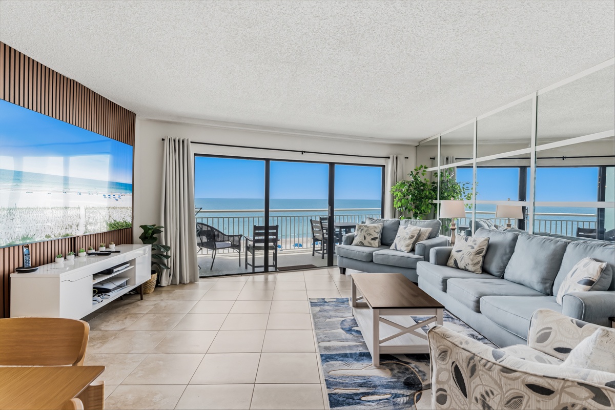 Sink into plush sofas and gaze through floor-to-ceiling windows at stunning ocean vistas—your perfect beachfront escape awaits with coastal breezes and panoramic blue horizons.