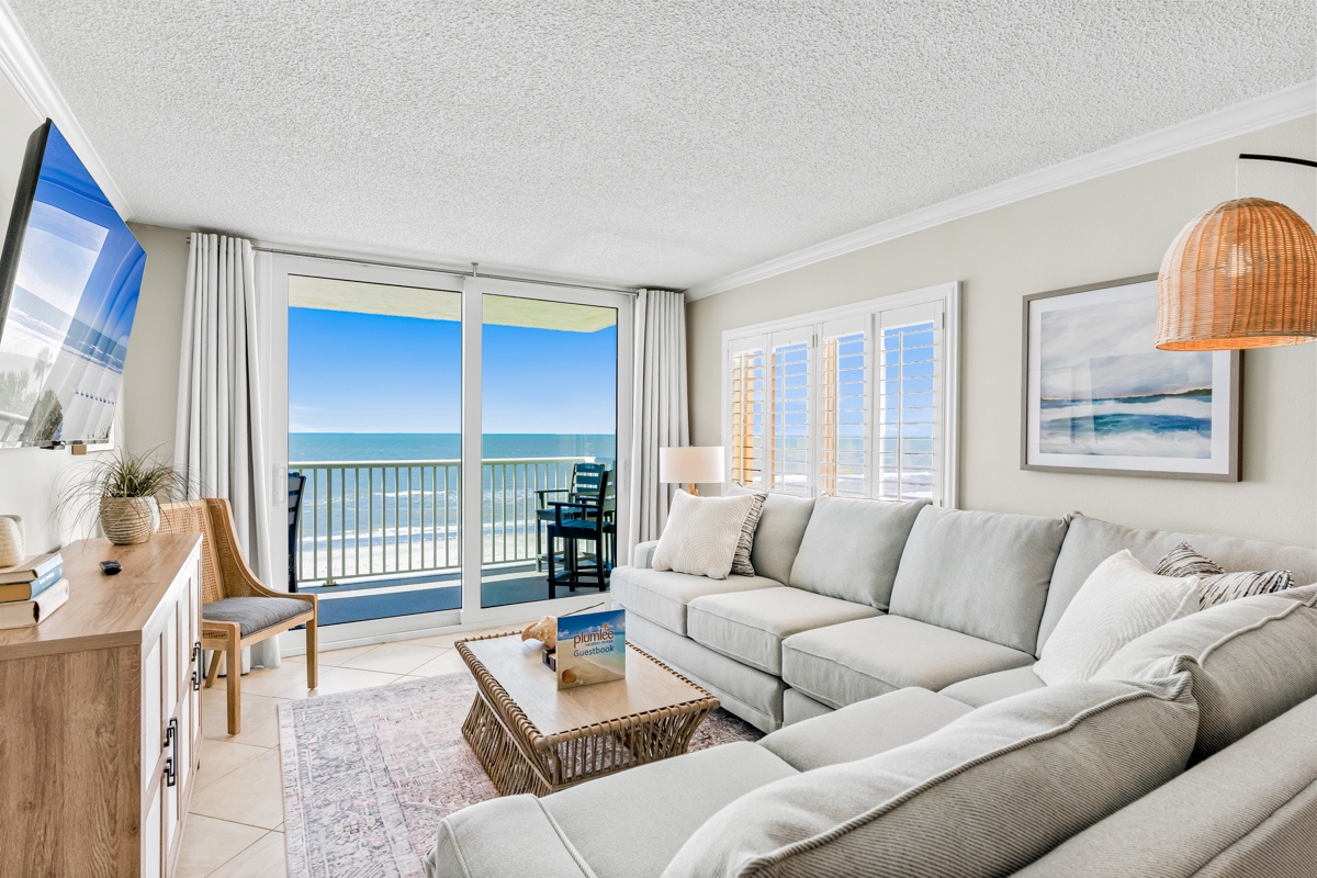 Wake up to endless ocean views from your spacious living room, where plush seating and natural light create the perfect coastal retreat.