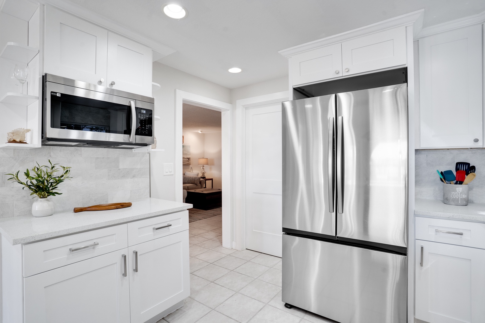 Your gleaming kitchen features stainless steel appliances and crisp white cabinets, creating the perfect space for culinary adventures.