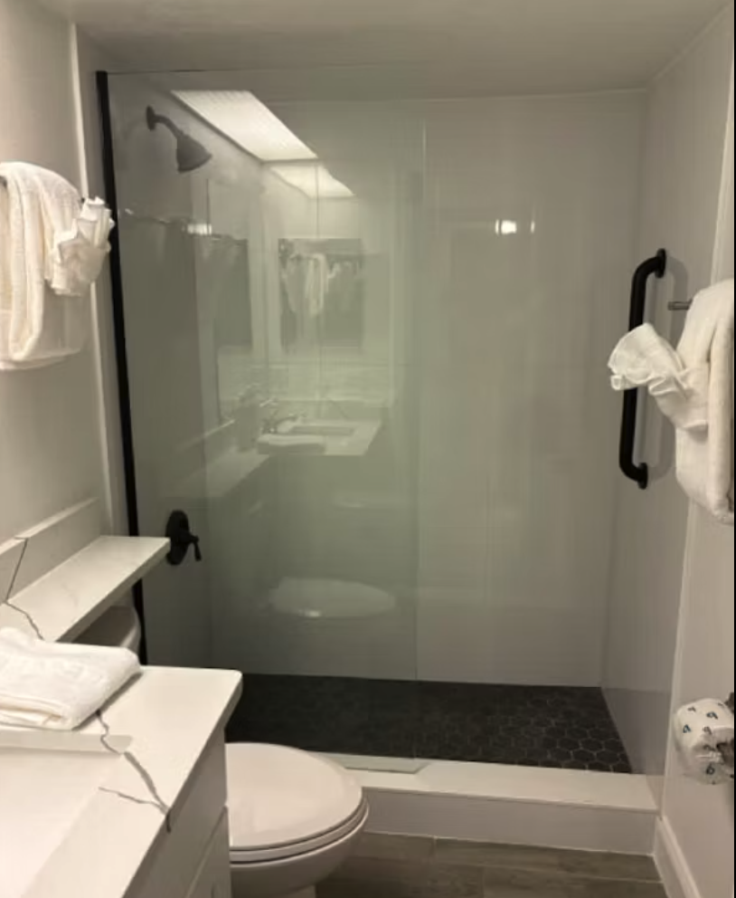 Step into your private spa-like bathroom with a spacious walk-in shower featuring sleek glass doors and a rainfall showerhead that invites you to unwind after a day of adventure.