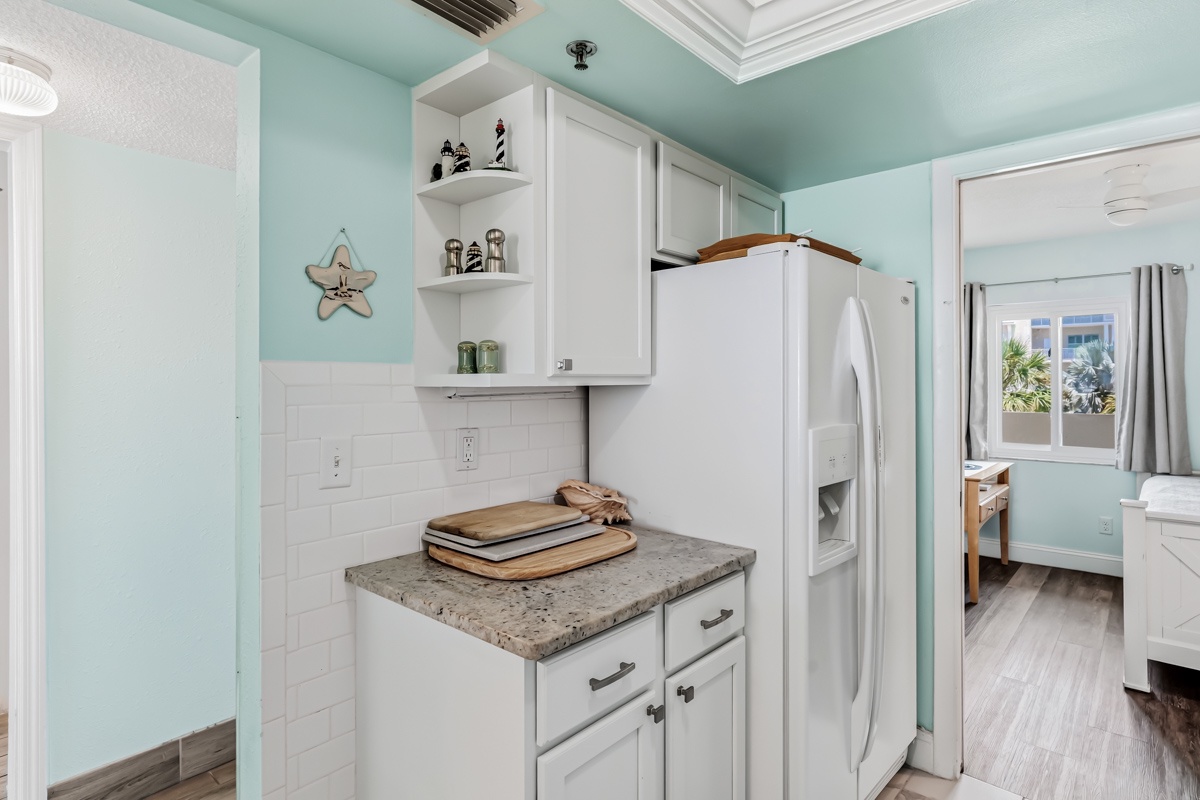 Step into your bright coastal kitchen, where soft aqua walls and white cabinetry create a serene beachy vibe. Fresh, functional, and inviting—your perfect home base for morning coffee.