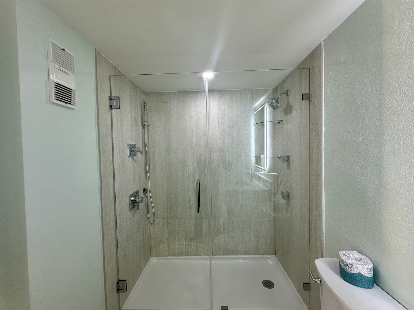 Step into your sleek, modern shower with rainfall showerhead and glass enclosure—your perfect sanctuary for refreshing mornings.