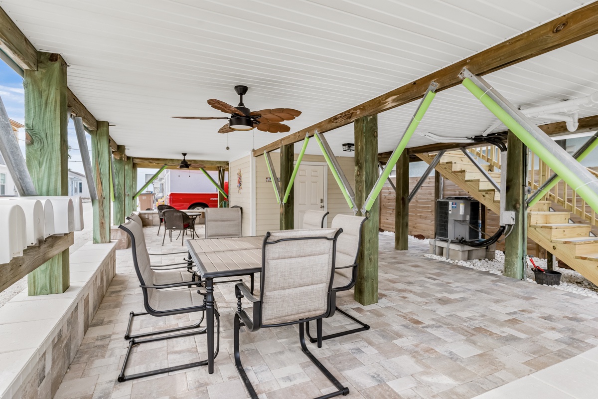 Relax in your spacious covered outdoor living area with comfortable seating and ceiling fans keeping you cool.