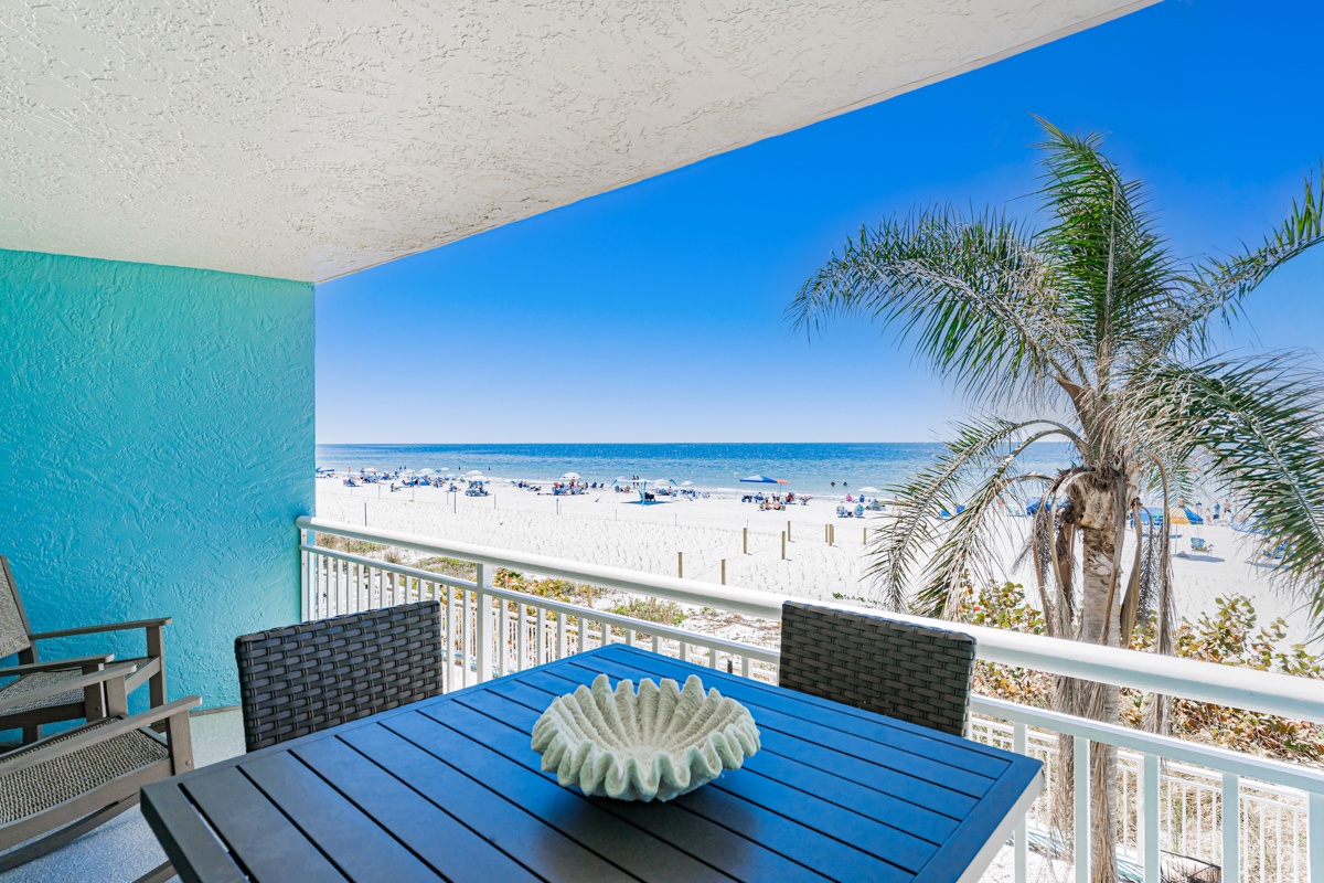 Relax on your private beachfront balcony with stunning ocean views, tropical palms swaying nearby, and soft white sand stretching endlessly before you.