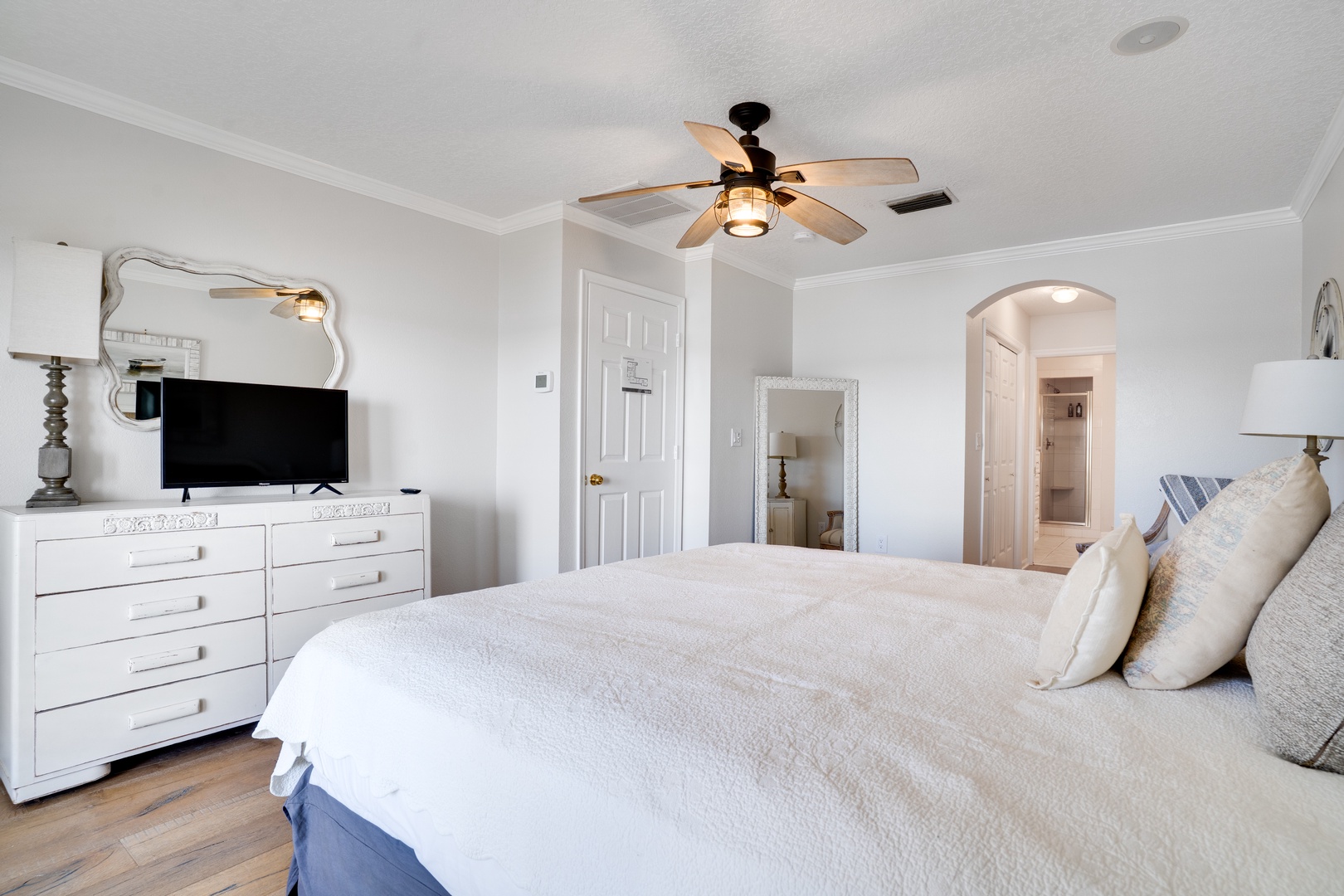 Drift off in your serene bedroom with soft linens, elegant furnishings, and a ceiling fan keeping you comfortable all night long.