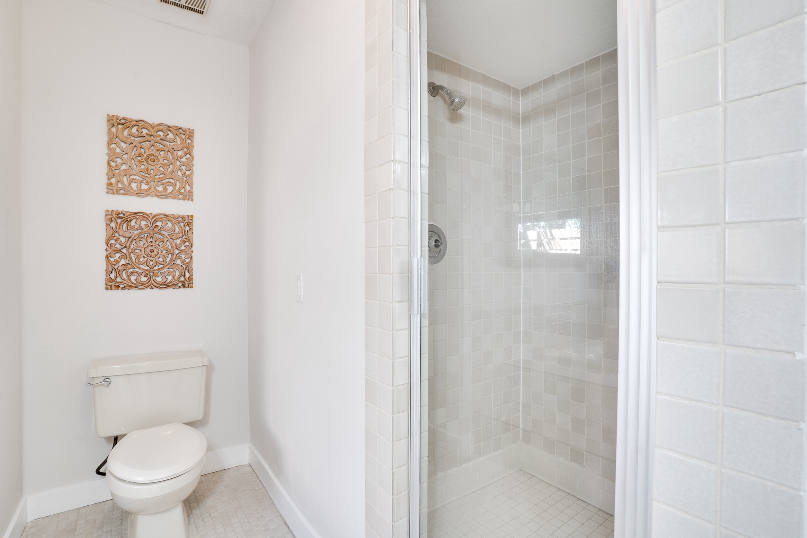 Step into your pristine private bathroom, where clean white tiles and a spacious glass shower create your perfect morning routine sanctuary.