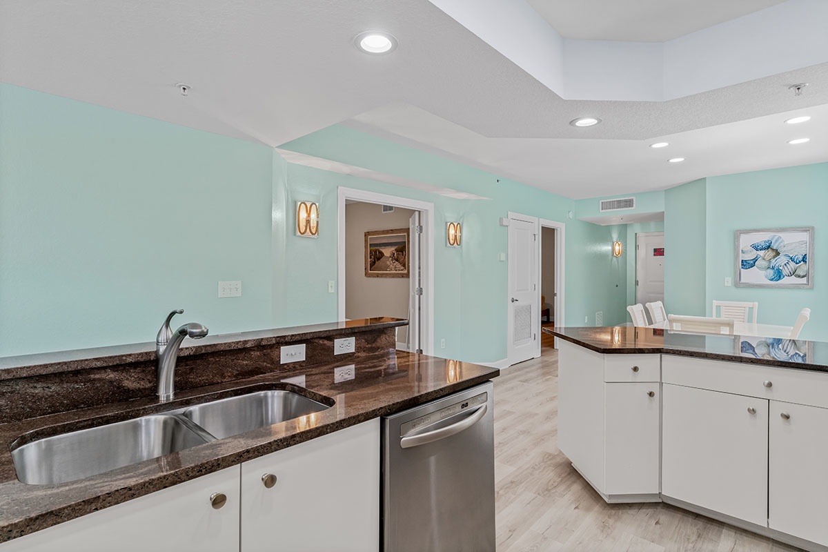 Your modern kitchen features granite countertops, stainless steel appliances, and calming mint walls that create a fresh, inviting cooking space.