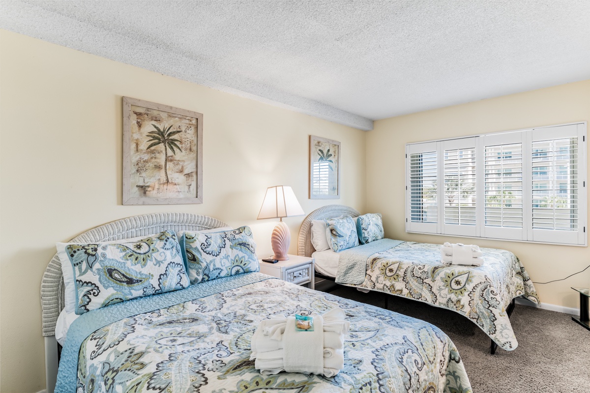 Drift off in a light-filled bedroom where coastal artwork, wicker headboards, and beach-inspired linens set the tone for your restful stay. 2 Full beds
