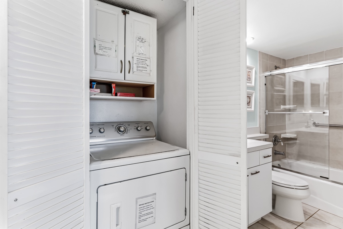 Your stay includes convenient in-unit laundry facilities, with a full-size washer and dryer tucked neatly into a closet space, plus a modern bathroom just steps away.