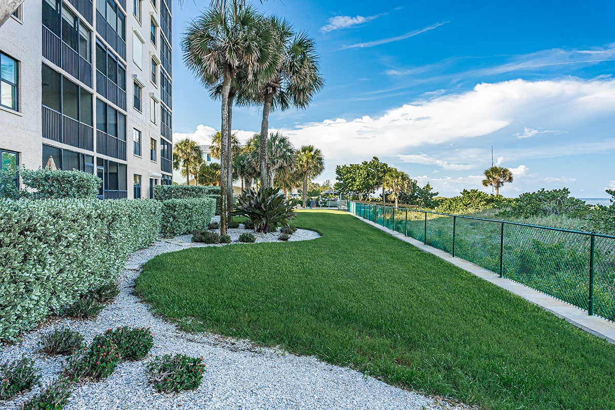 Property grounds feature lush landscaping with palm trees and manicured lawns under beautiful Florida skies.