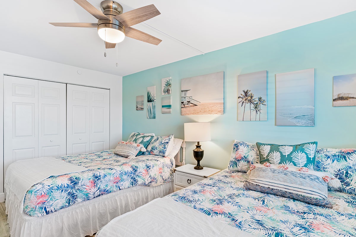 Wake up refreshed in your tropical twin bedroom with coastal artwork and breezy ceiling fan keeping you comfortable.