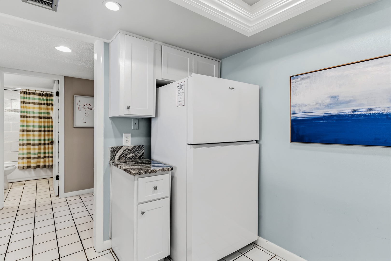 Your kitchenette features classic white cabinetry, granite counters, and all essential appliances—everything you need to prepare a quick snack or a full homestyle meal during your stay.