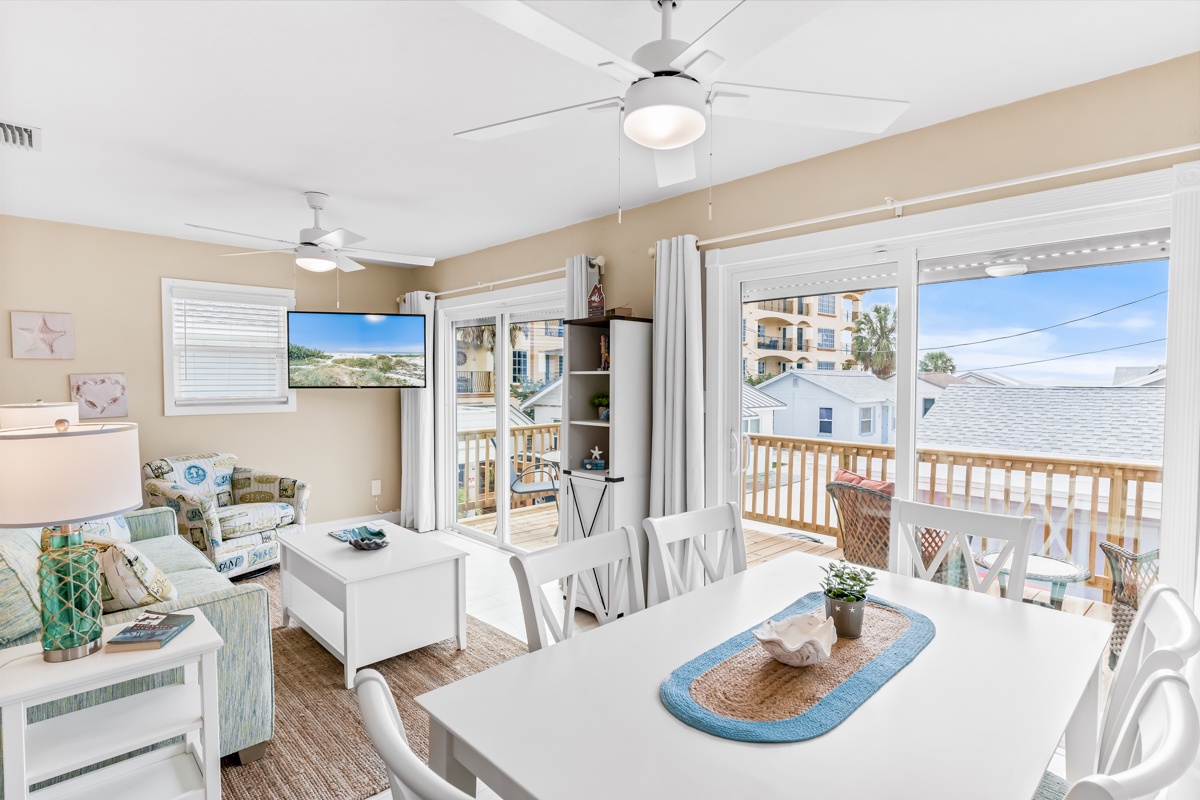 Your bright, open living space flows seamlessly to a private balcony where coastal breezes keep you comfortable while you dine or relax together.