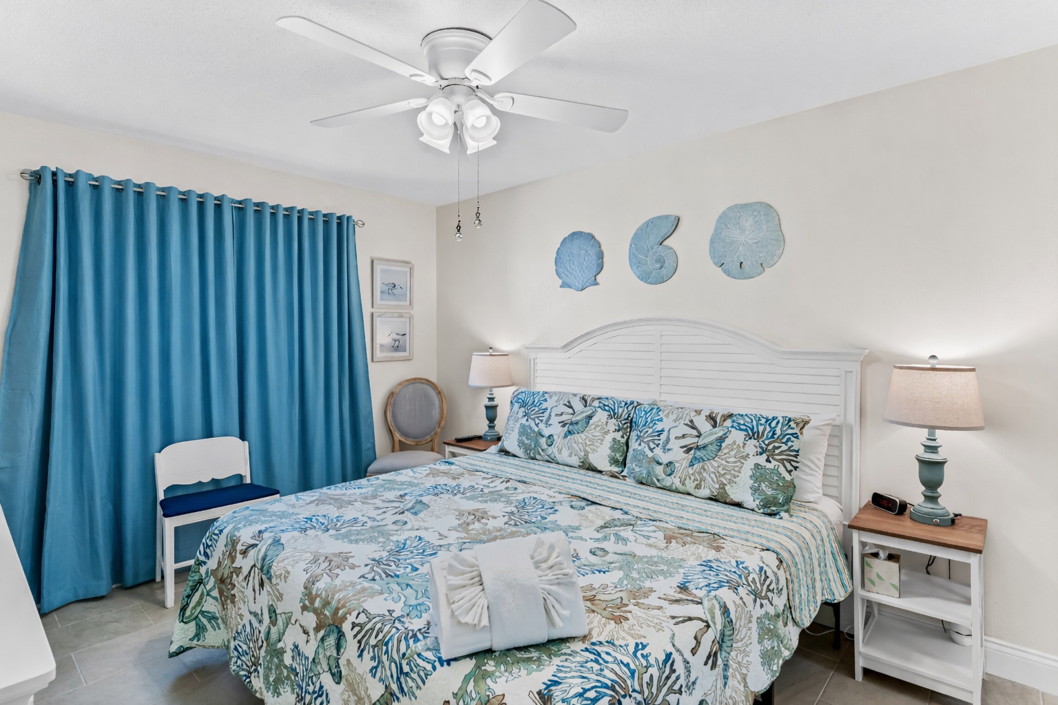 Drift into coastal dreams in your ocean-themed bedroom, complete with seashell décor and refreshing ceiling fan breeze.