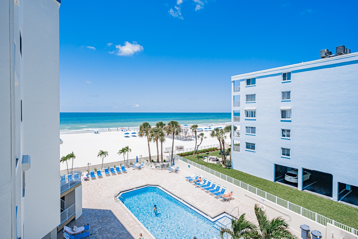 Step onto your balcony and take in stunning ocean and pool views framed by swaying palms and soft white sand—pure paradise awaits.