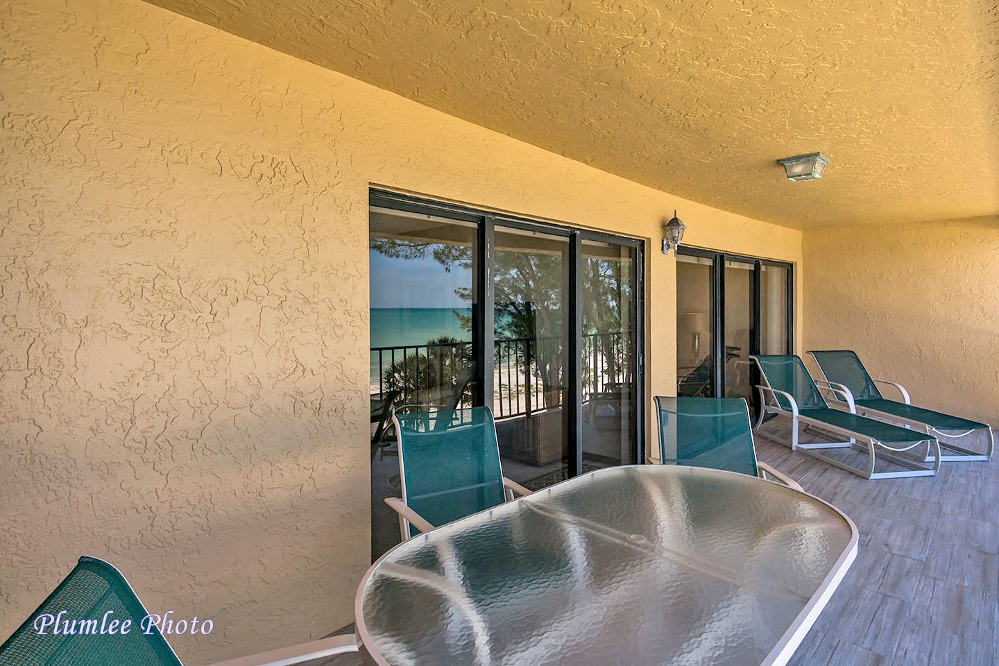 Balcony has a dining table and loungers