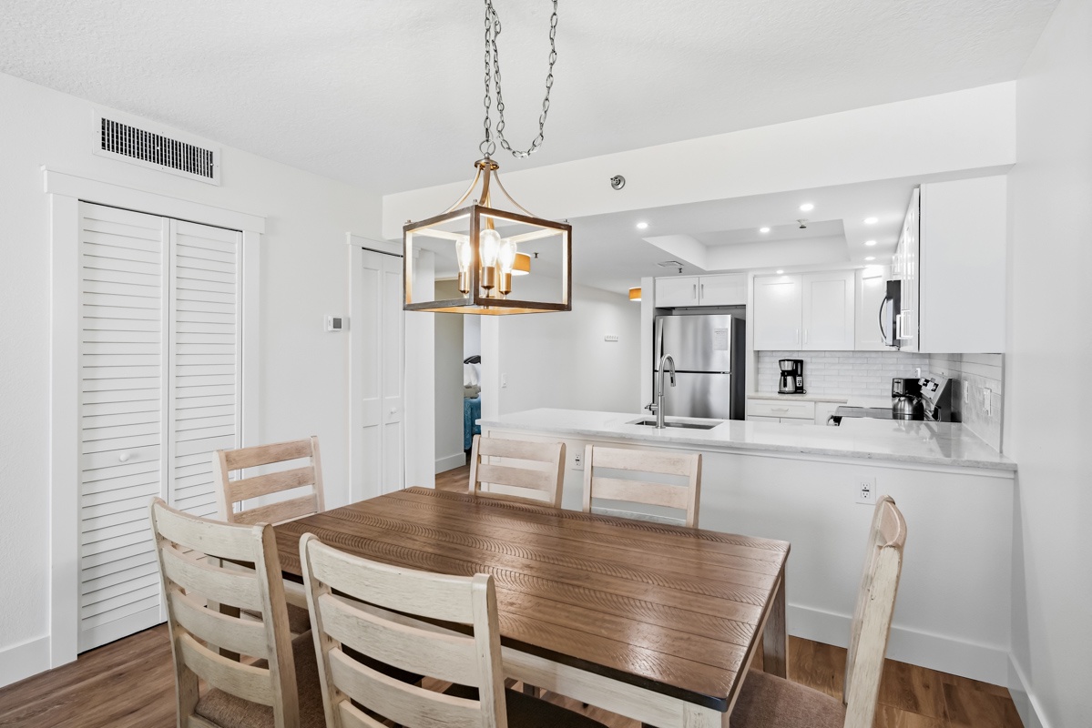 Gather around your spacious dining table beneath elegant lantern lighting, with a modern kitchen just steps away for convenient meal prep.