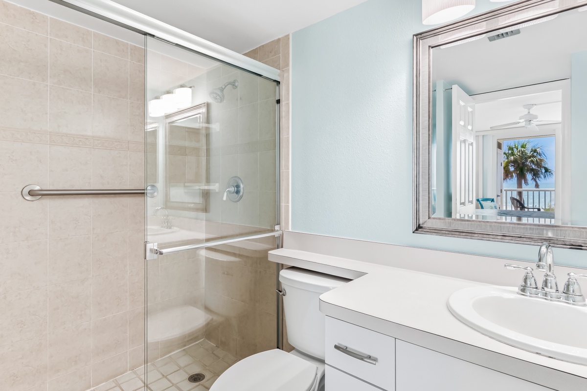 Refresh in your bright, coastal-inspired bathroom with a roomy walk-in shower, gleaming surfaces, and soft natural light throughout.