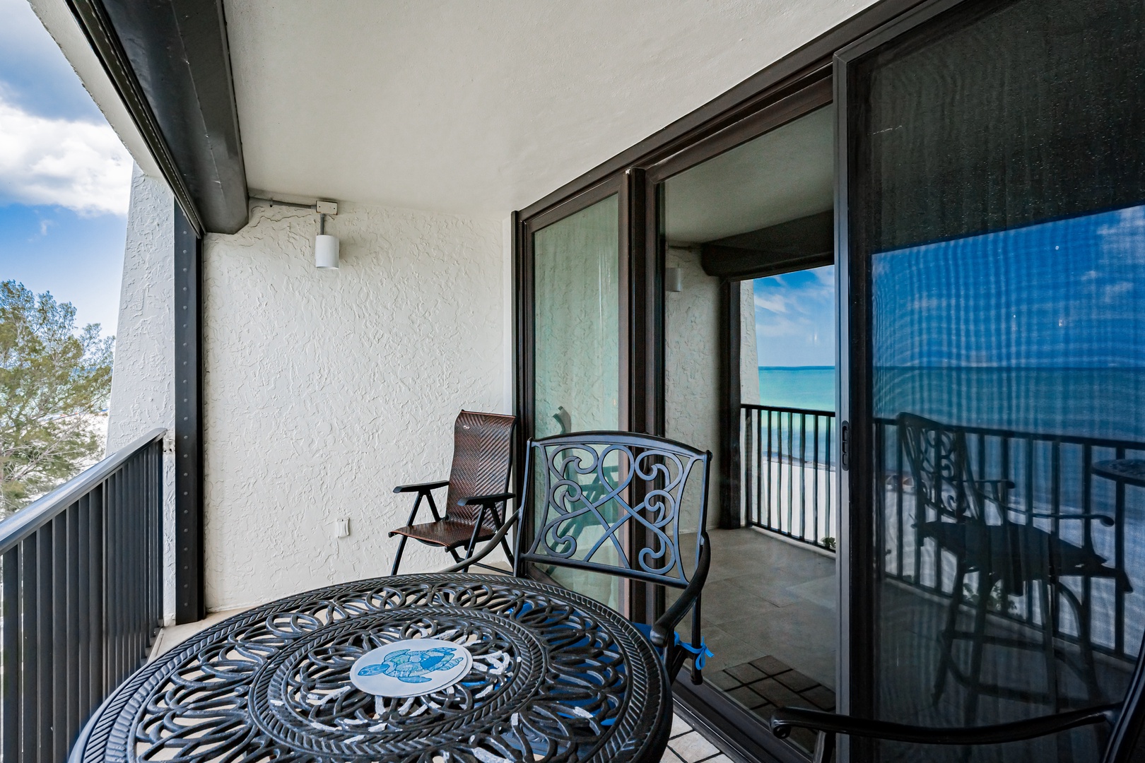 Step onto your private balcony and enjoy morning coffee with stunning ocean views, all while relaxing in comfortable outdoor seating designed for peaceful moments.