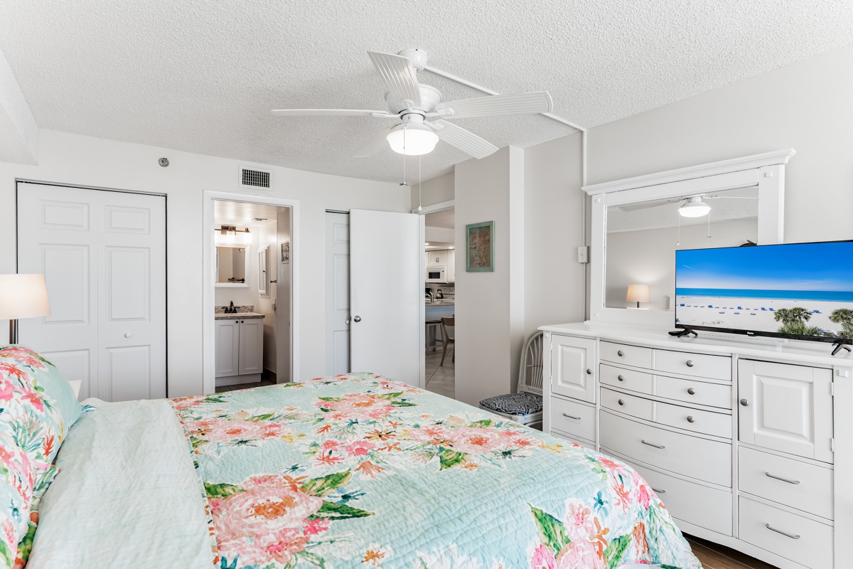 Unwind in your bright, airy bedroom with coastal charm. Soft linens invite restful sleep, while the ceiling fan keeps you cool. Your dresser holds all you need for a carefree stay.