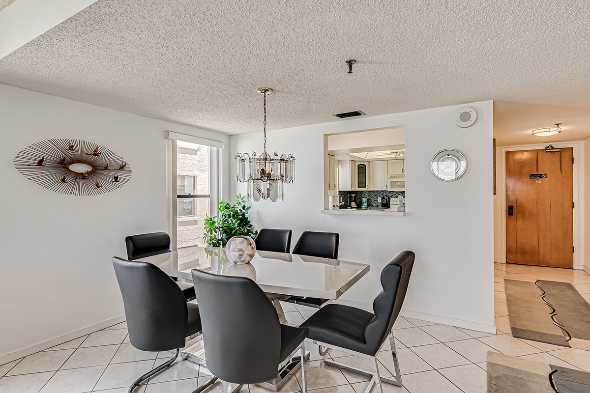Gather around your elegant dining table for memorable meals, with modern furnishings and an open view to the kitchen creating the perfect space for connection.