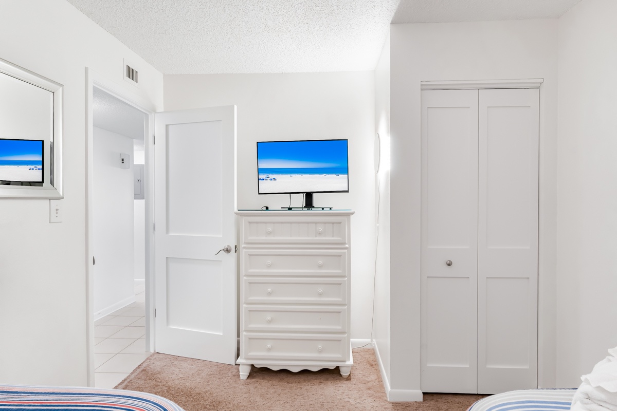 Settle into this bright, airy bedroom where white furnishings and coastal-inspired décor create a peaceful retreat for your stay.