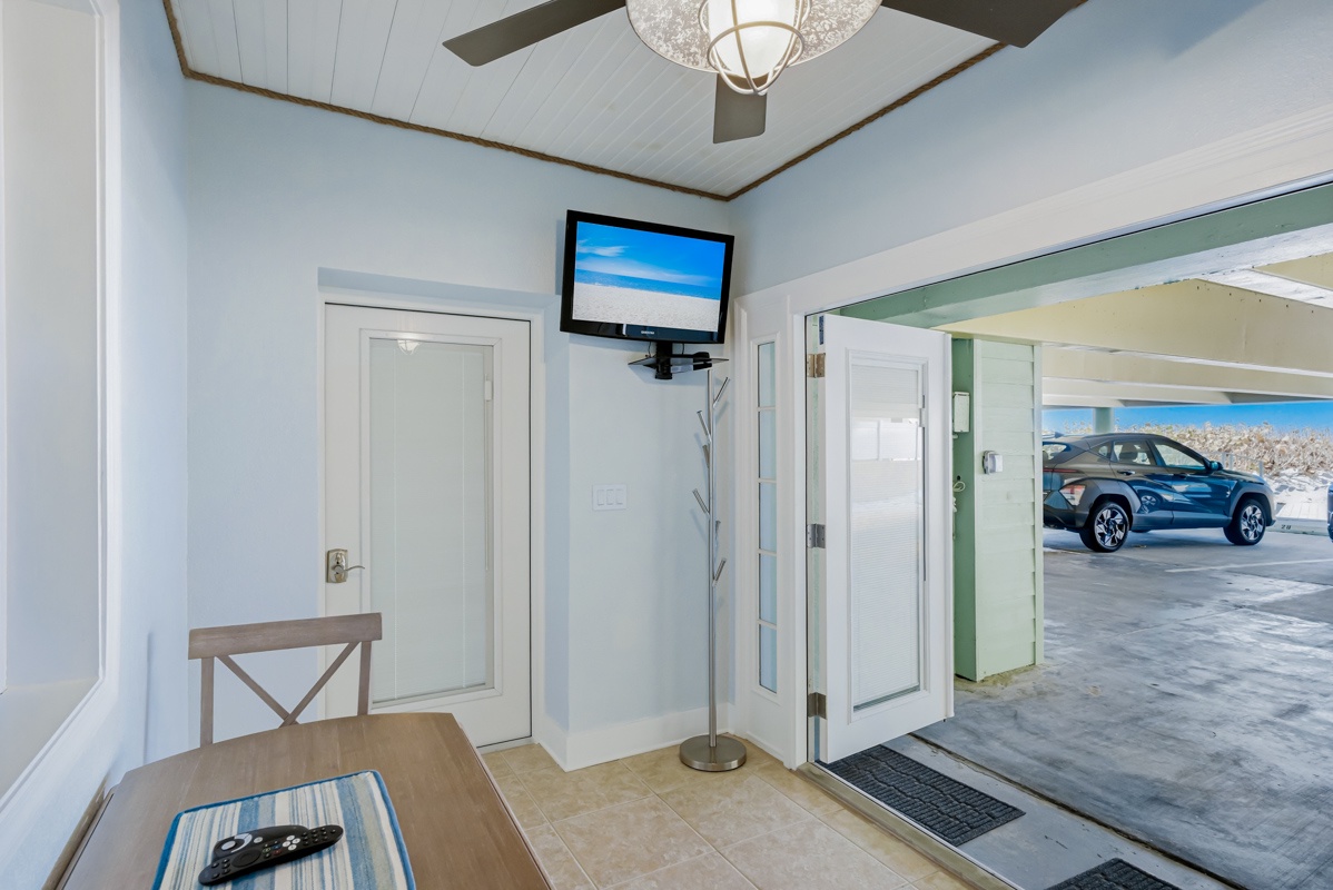 Dining table with TV access to front patio and beach