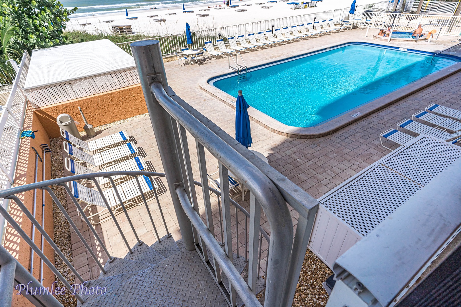 Private spiral stairs down to pool area