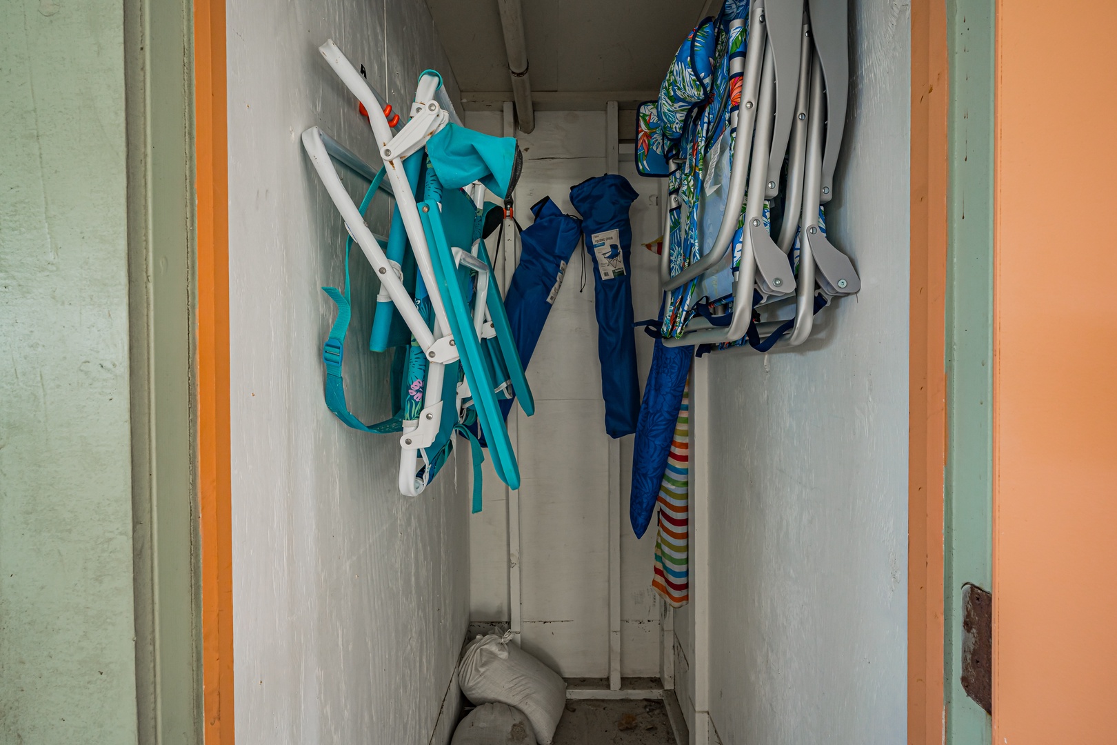 A convenient storage closet stocked with beach chairs, umbrellas, and outdoor gear to enhance your seaside adventures and sunny days by the water.