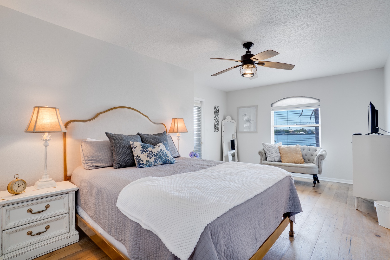 Drift off in your elegantly appointed bedroom, where soft linens meet charming nautical touches and peaceful water views.