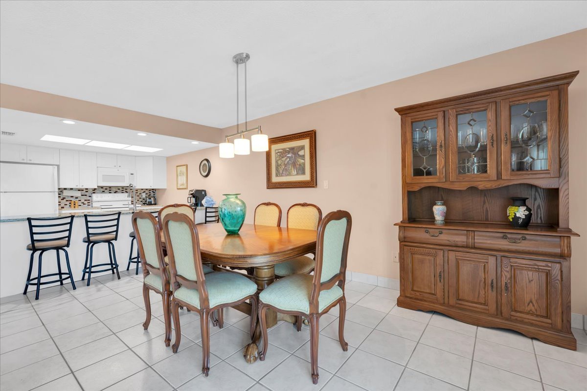 Gather around this elegant dining table for meals and memories, with an open kitchen just steps away and beautiful furniture completing your vacation home.