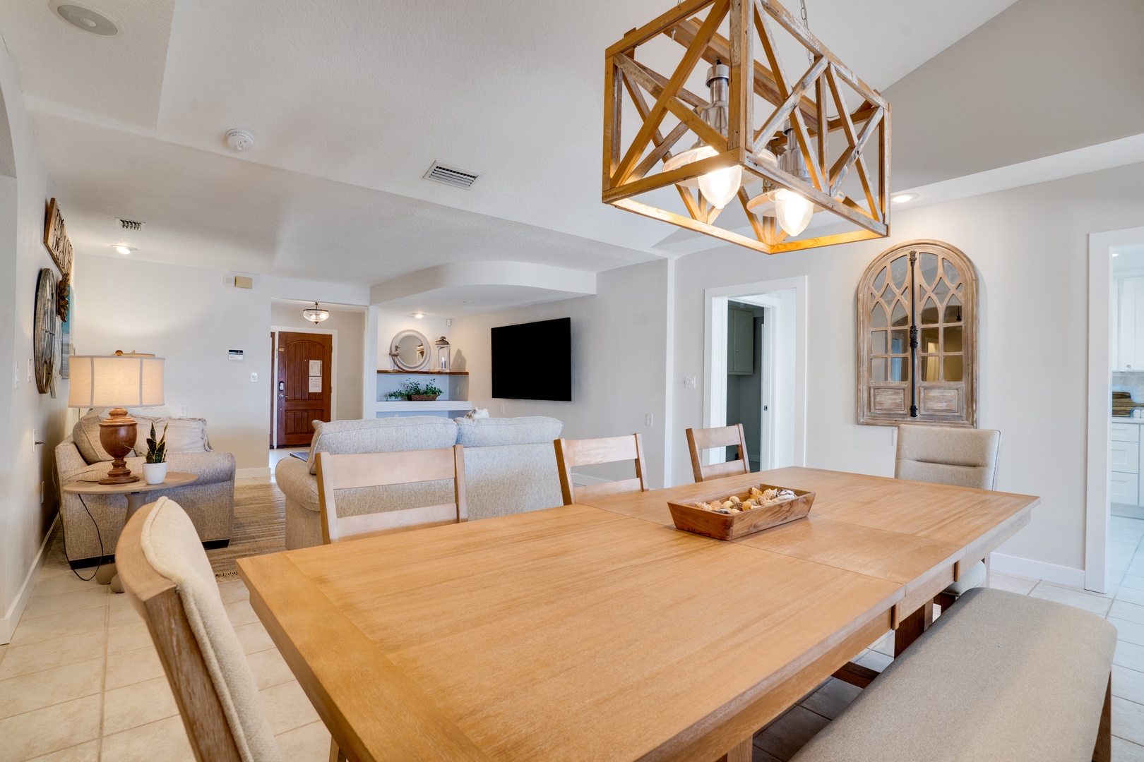 Gather around this stunning dining table where memorable meals and conversations await in your beautifully designed open-concept space.