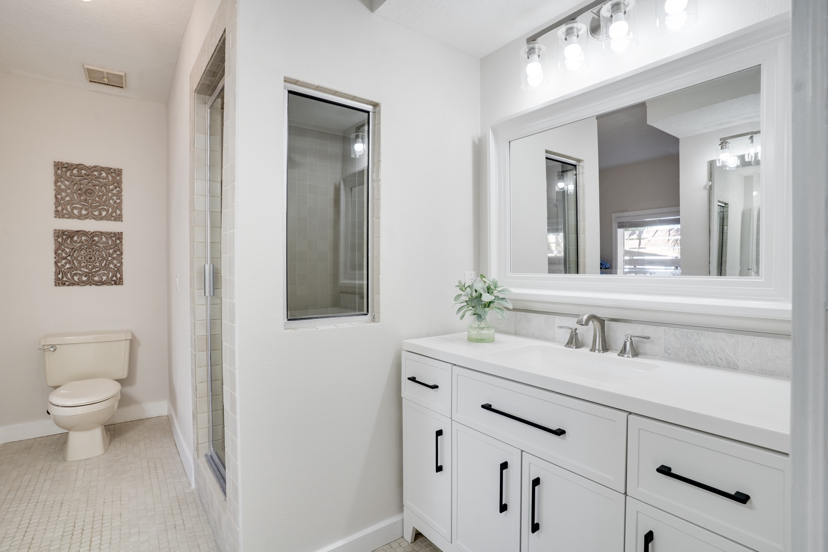 Unwind in your pristine bathroom with marble countertops, modern lighting, and a spacious walk-in shower for ultimate comfort.