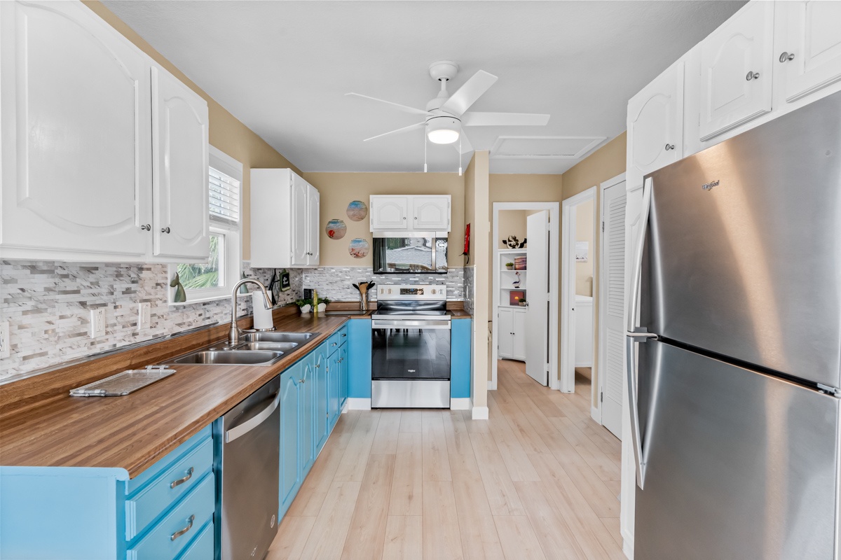 Cook up memories in your fully equipped kitchen with modern appliances, beautiful wood counters, and cheerful coastal-blue cabinets.