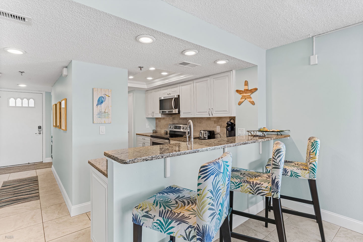 Additional seating at the wet bar between the Kitchen and Dining area.