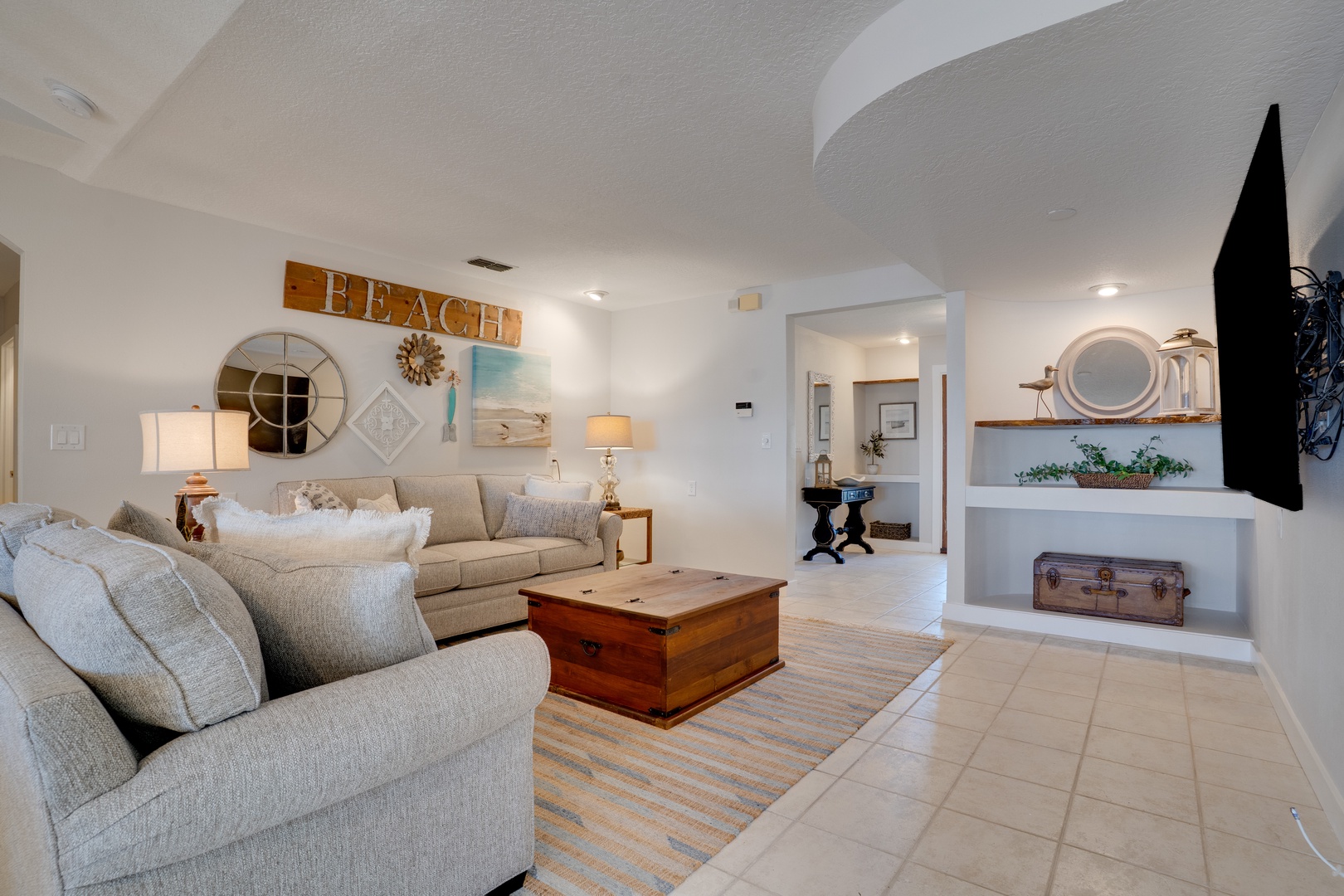 Sink into plush coastal comfort where beach vibes meet modern luxury in your spacious living room.