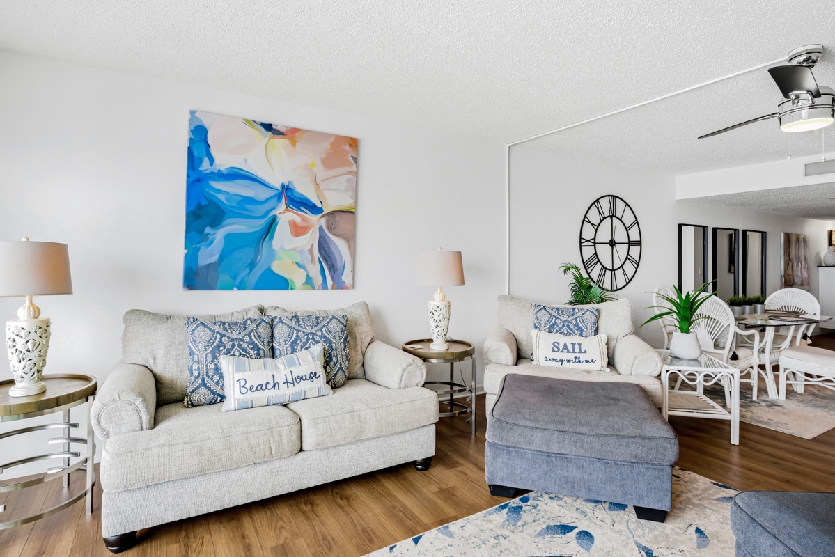 Relax in your coastal-themed living space with comfortable seating, vibrant artwork, and beach-inspired touches that make you feel right at home.